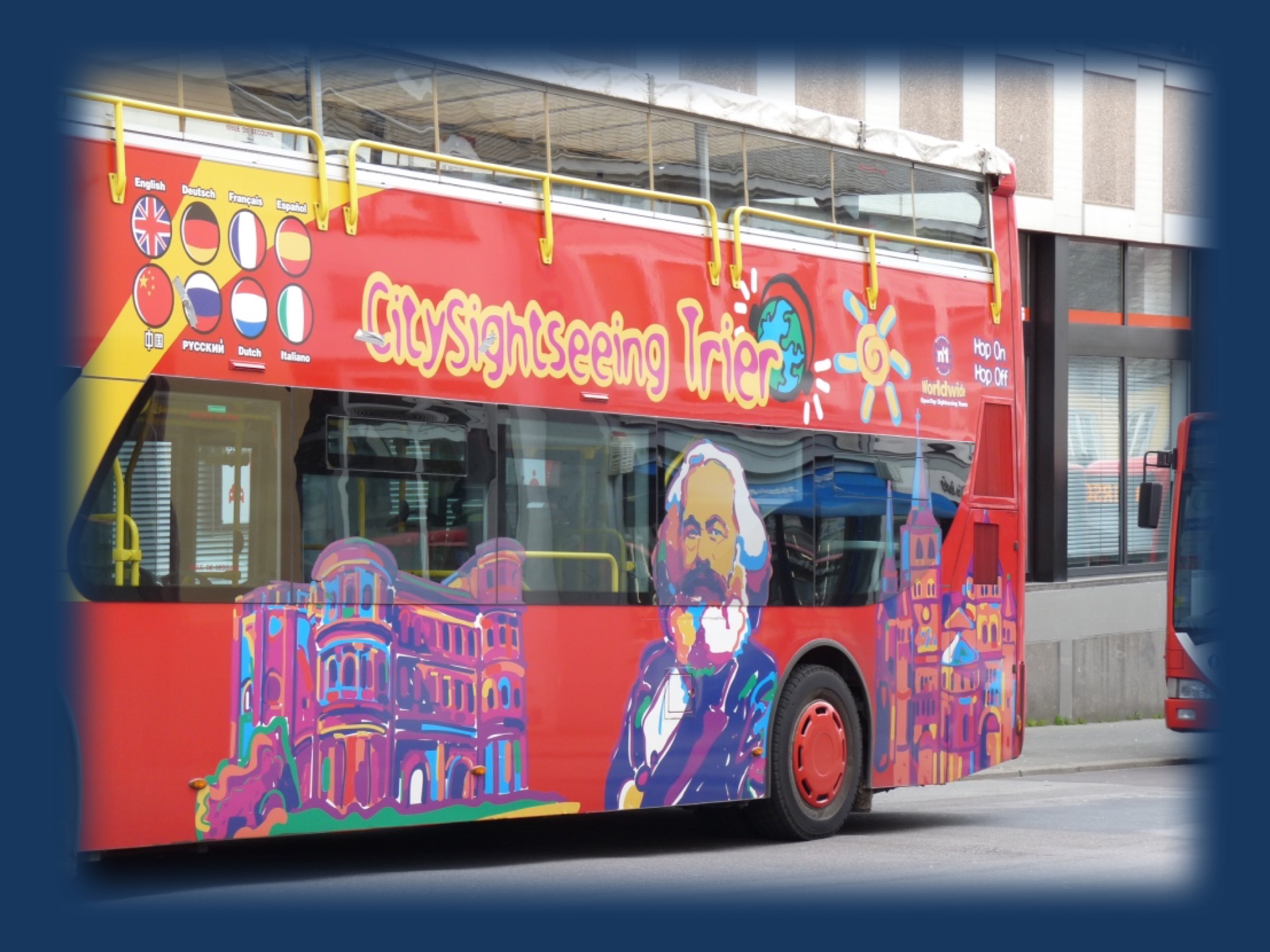 Figure 1. A tourist bus in Trier, Germany featuring Porta Nigra, Karl Marx, and the Trier cathedral.